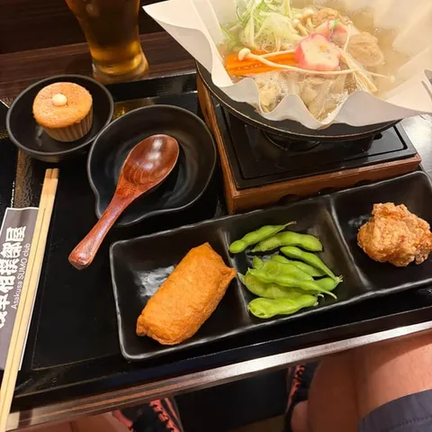 A chanko hot pot served with side dishes
