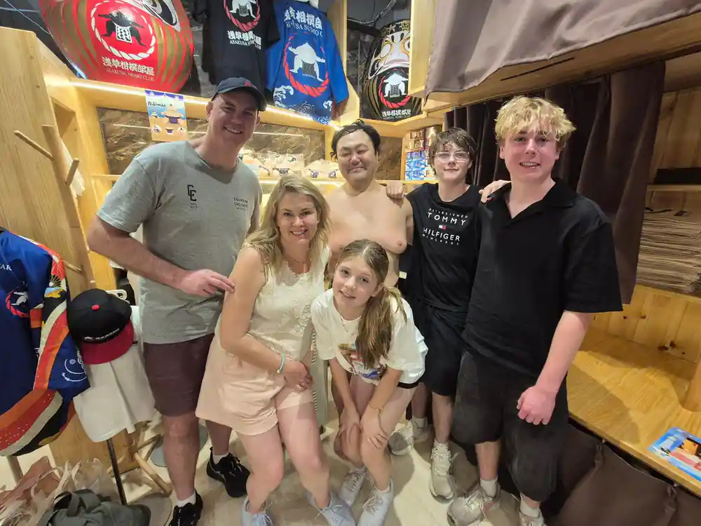 Group of six people posing together indoors