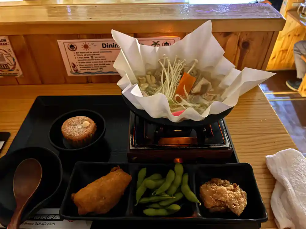 Japanese meal set with soup, vegetables, and bread
