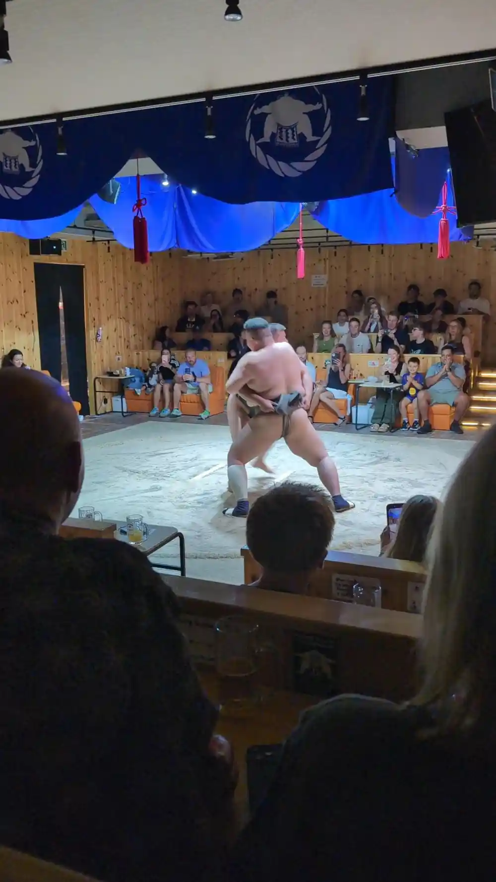 Sumo wrestling match with audience seated ringside
