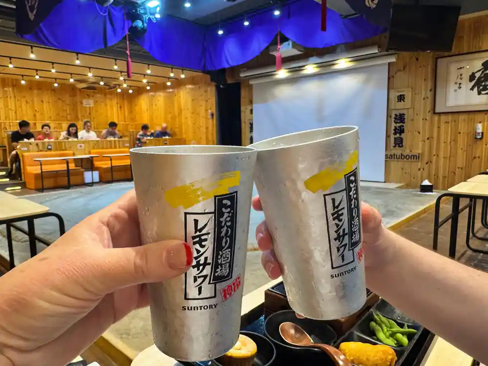 Two metal cups with Japanese text at indoor venue