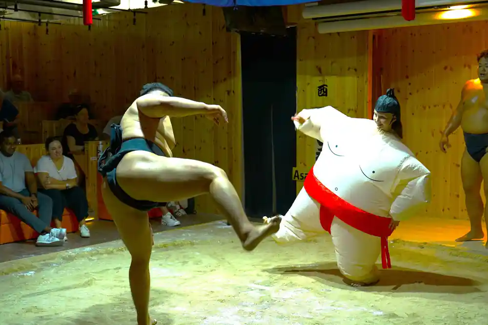 Two sumo wrestlers grappling in ring during match
